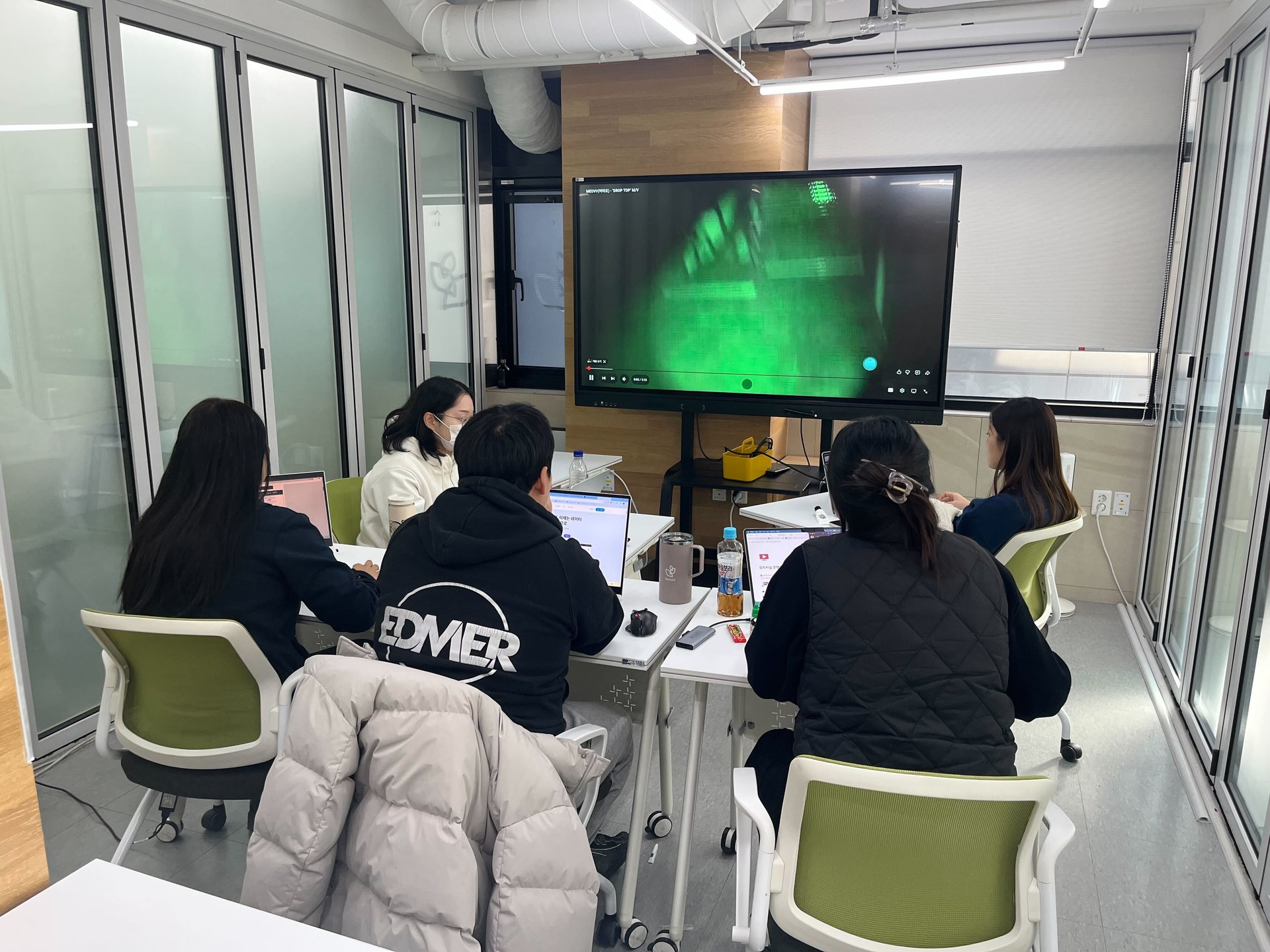 Team project participants discussing documents and video materials